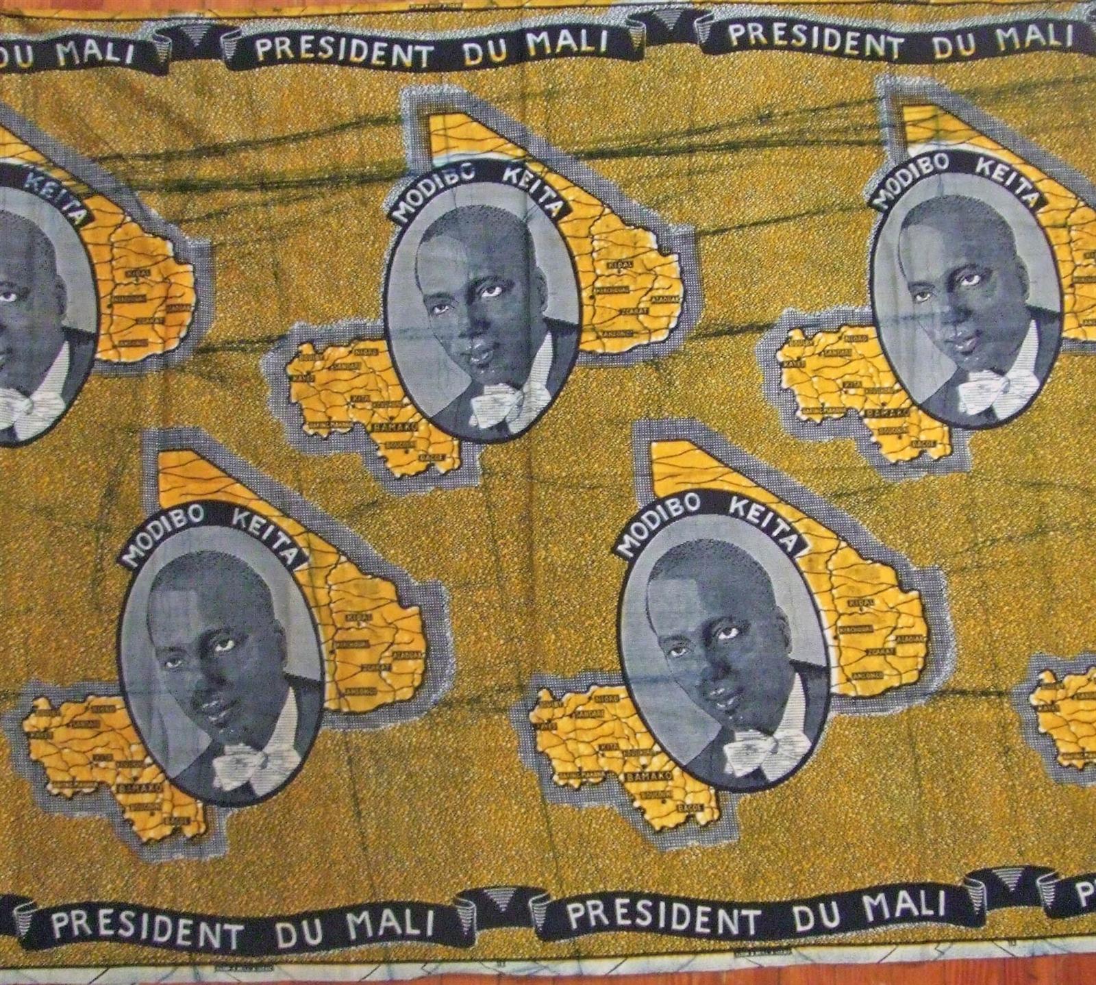 Ochre commemorative cloth repeating a portrait of Modibo Keïta inside the outline of Mali