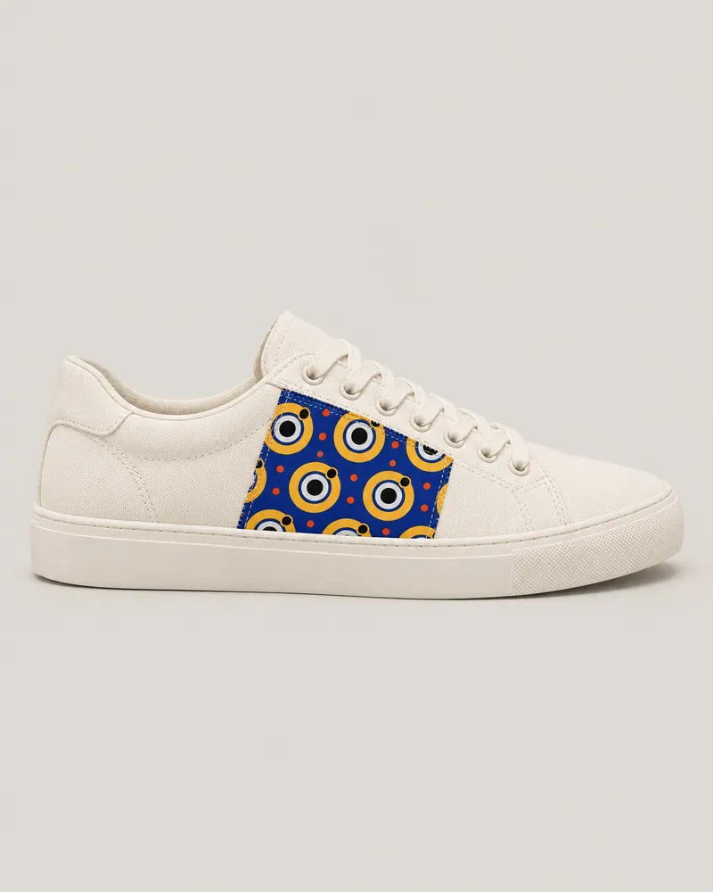 Ivory low-top sneaker with a sewn wax side panel, toe pointing right. AI-generated product concept.